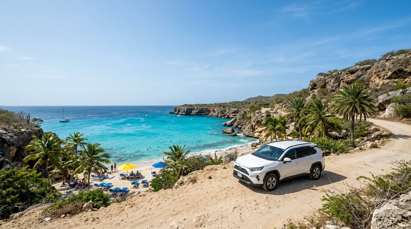 Rental SUV parked above a turquoise beach cove in Curaçao
